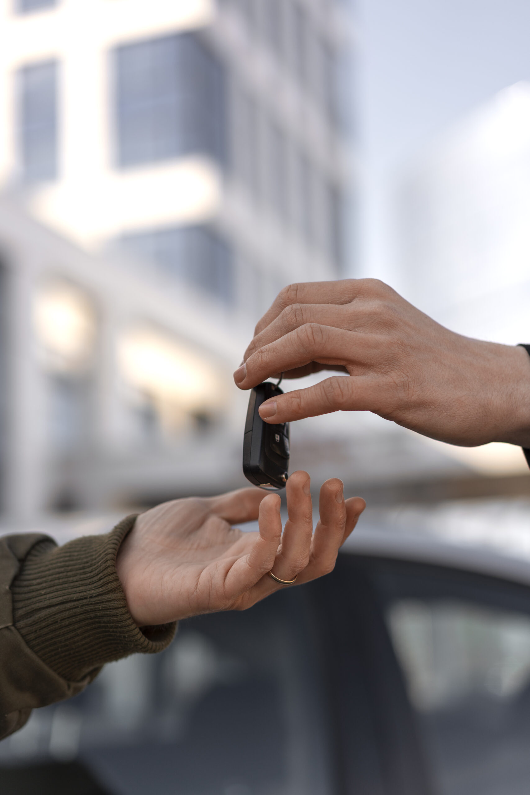 side-view-hands-holding-car-key